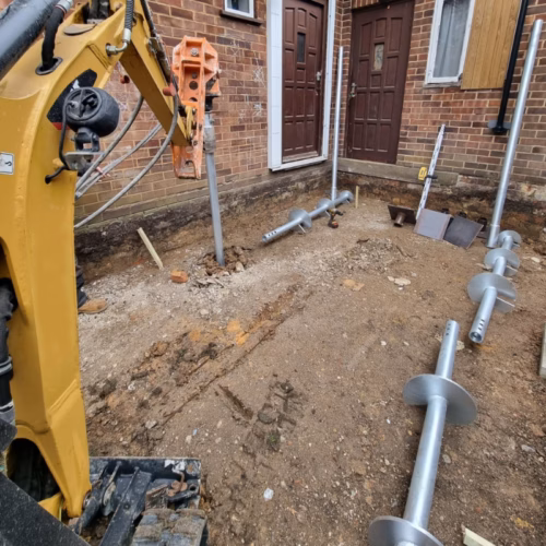 Screw piling outside property