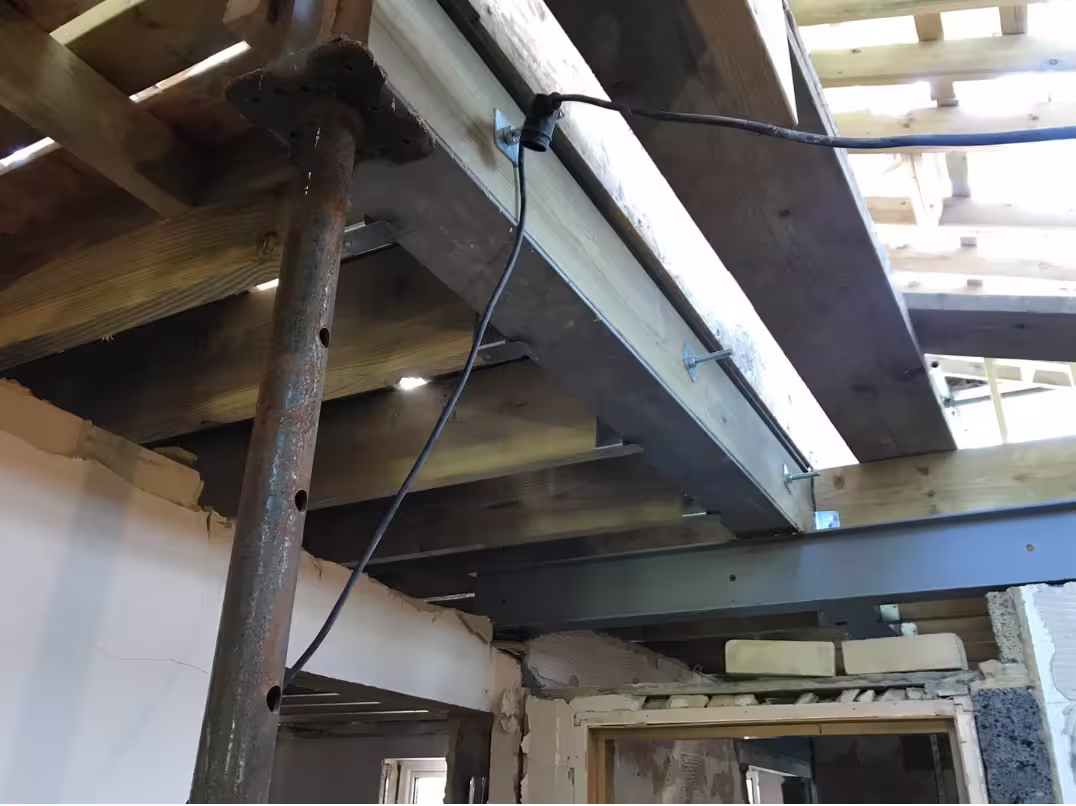 Steel beam installed beneath a timber structure